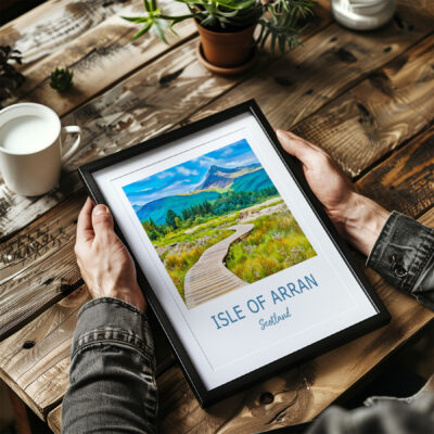 Framed Isle of Arran photo on wooden table.