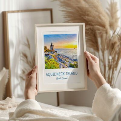Framed Aquidneck Island lighthouse print in cozy setting.