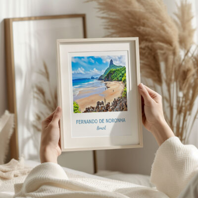 Hands holding framed Fernando de Noronha beach photo.