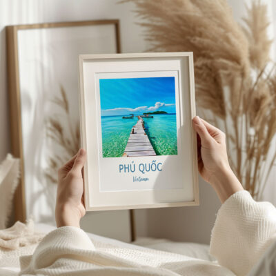 Person holding framed ocean photo of Phú Quốc, Vietnam.