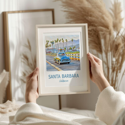 Framed Santa Barbara art with vintage car scene.