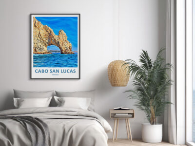 Cabo San Lucas poster above bed in modern room.