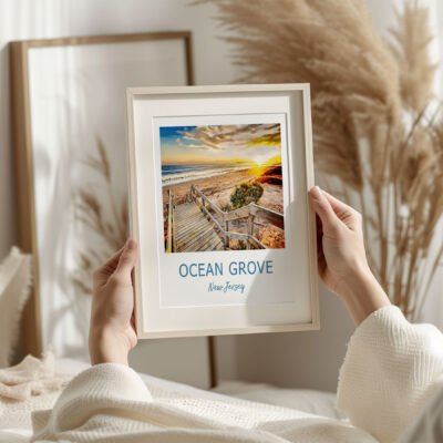 Person holding Ocean Grove beach photo in frame.