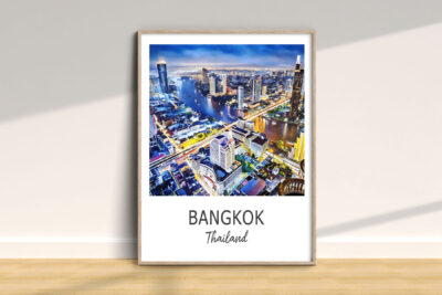 Framed Bangkok cityscape poster on wall.