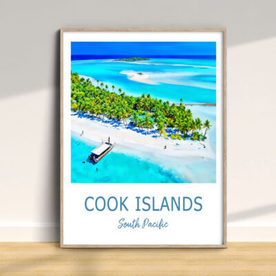 Framed Cook Islands beach poster on wooden floor.