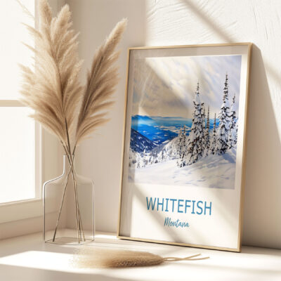 Framed Whitefish Montana snowy landscape art on shelf.