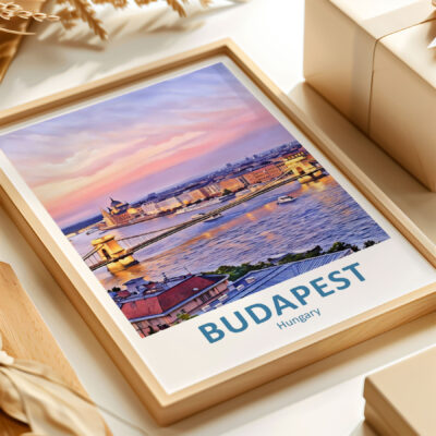 Framed Budapest skyline artwork on display table.