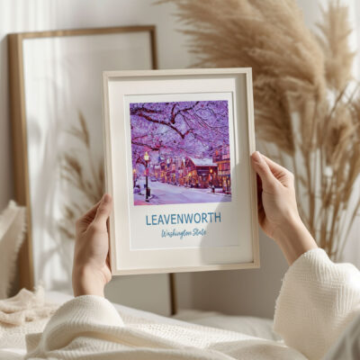 Framed Leavenworth winter scene in cozy room.