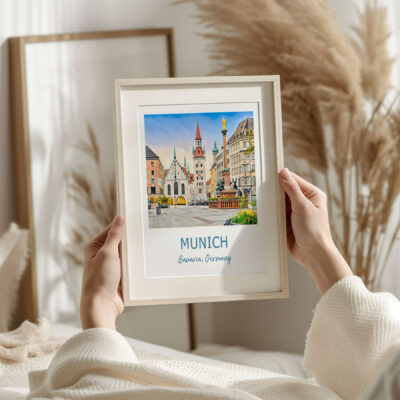 Person holding Munich photo frame indoors.