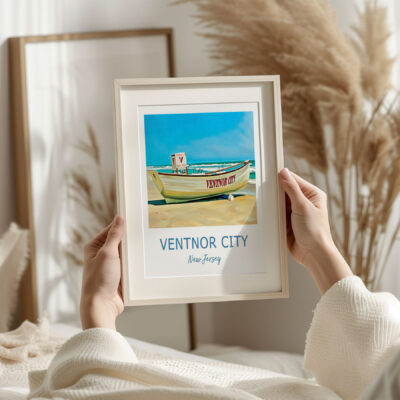 Framed Ventnor City beach art print held by hands.