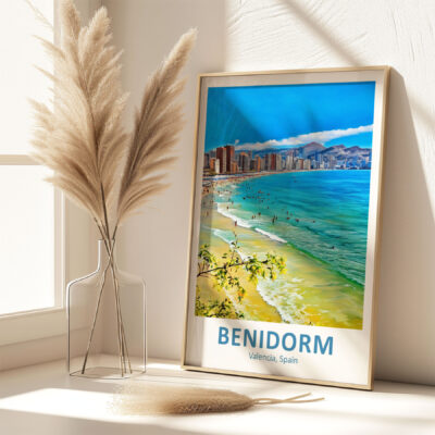 Framed Benidorm beach poster beside pampas grass vase.