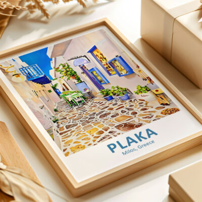 Framed photo of Plaka, Milos, Greece on table.
