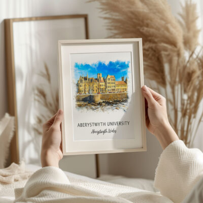 Hand holding Aberystwyth University framed print.