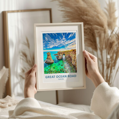 Framed Great Ocean Road poster in cozy room.