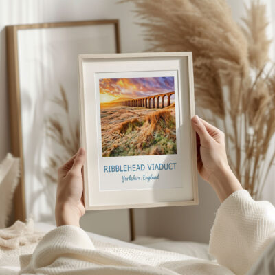 Person holding Ribblehead Viaduct photo in frame