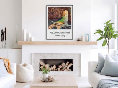 Living room with Arcomagno Beach poster on wall.