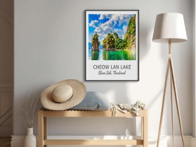 Cheow Lan Lake poster on beige wall, hat on bench.