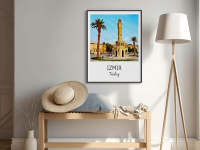 Framed Izmir picture, hat, and lamp in room.