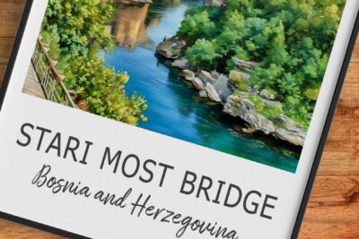 Stari Most Bridge over Neretva River, lush surroundings.