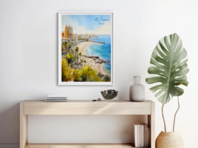 Framed St. Tropez beach art on wall shelf.