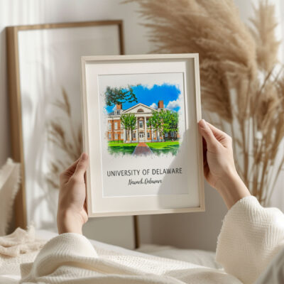 Hands holding University of Delaware framed artwork.