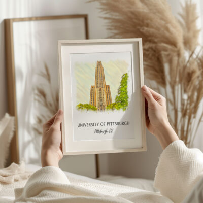 Framed University of Pittsburgh illustration held by person.